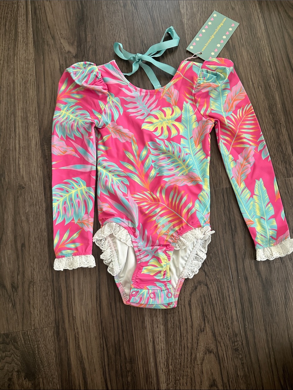Girls' Pink Tropical Long-Sleeve One-Piece Swimsuit with Lace Trim and Tie Back